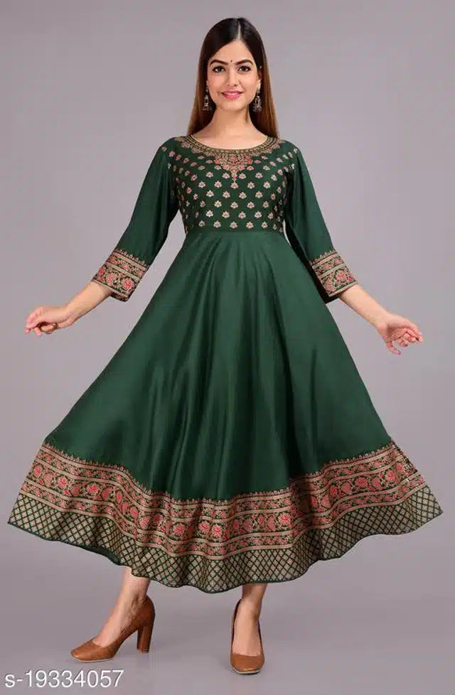 Green dress with patterned hem and sleeves on a gray background